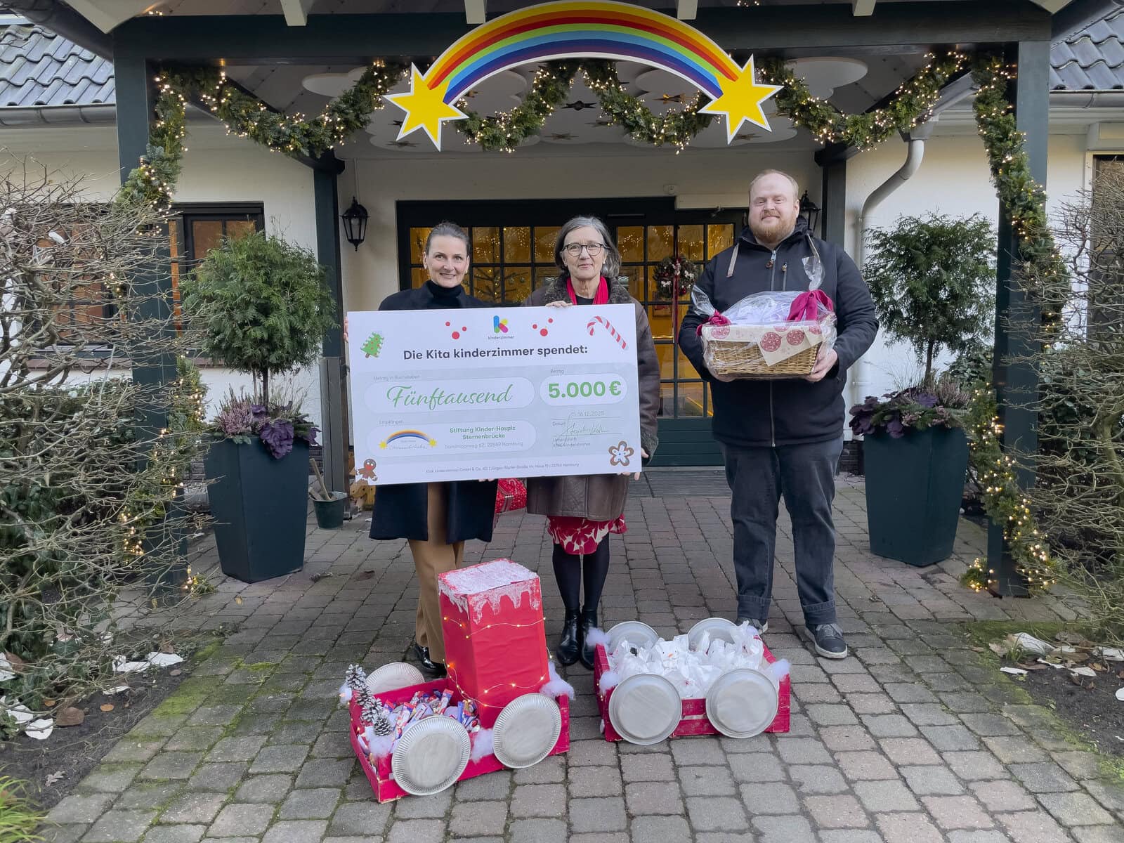 kita-kinderzimmer-hamburg-kinderhospiz-sternenbrücke Übergabe eines großen Spendenschecks und gebastelten Weihnachtsgeschenken vor dem Kinderhospiz Sternenbrücke in Hamburg Rissen